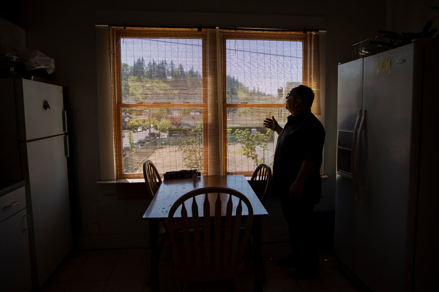 Mike Cross, Director, Pastor, & Housing Coordinator for Free on the Outside, shares about one of the common kitchen areas available for use for residents at The Carriage House in Oregon City, Ore., on Thursday, May 11, 2023. (Photo by Moriah Ratner for InvestigateWest)